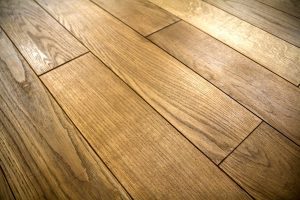 Close-up of a hardwood floor with warm-toned planks and visible grain seams.
